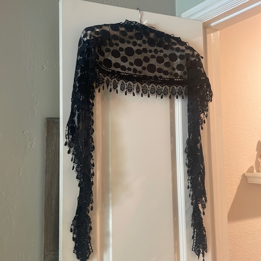 Lacy scarf/wrap. Simply elegant. A classic look to any outfit.
